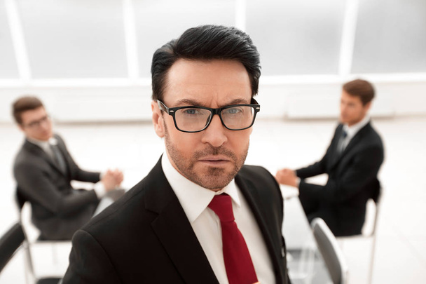 close up.serious businessman in the background of the conference room.business people - Photo, Image