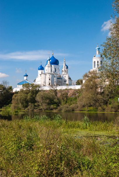Monastery on the river bank. Summer day blue sky - Foto, imagen