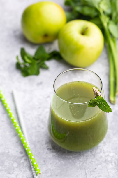 Green smoothie of apple, celery and mint on concrete background with copy space - Fotó, kép