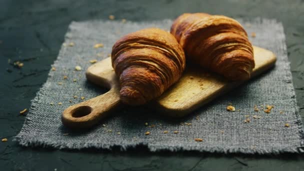 Fresh croissants on chopping board - Footage, Video