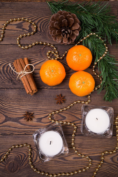 Christmas background - spruce branches with cones, mandarins cinnamon, star anise, Christmas decor. Flat lay, empty space. - Fotoğraf, Görsel