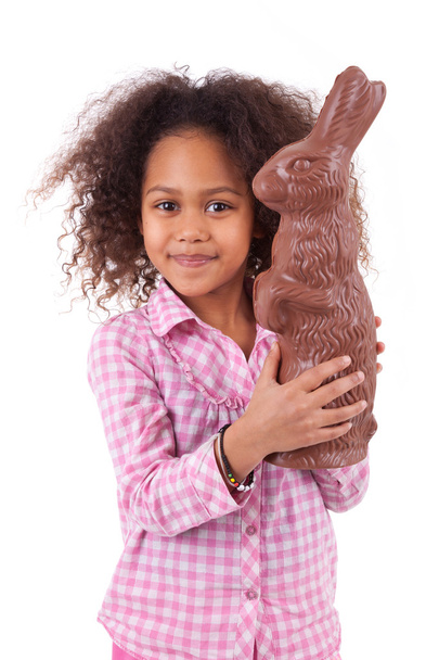 African Asian girl holding a giant chocolate rabbit - Foto, Imagen