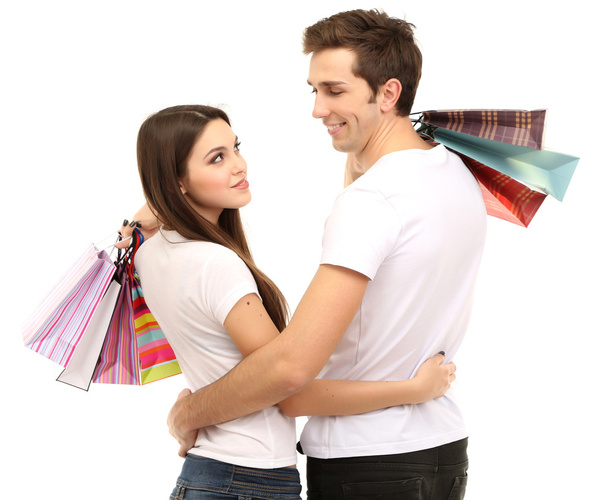 Young couple shopping and holding many shopping bags isolated on white - Foto, imagen