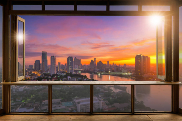 Beautiful Blank coffee shop or (cafe,restaurant) against blurred bangkok city view background, For montage product display or design key visual layout,  at sunrise. - Foto, Bild