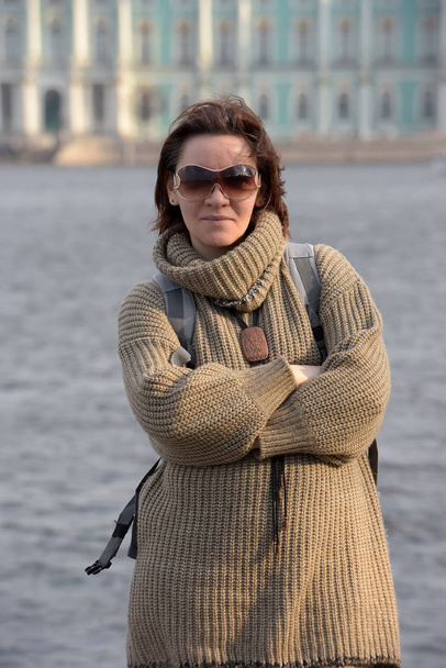 woman 40 years old brunette in a sweater and sunglasses - Fotó, kép
