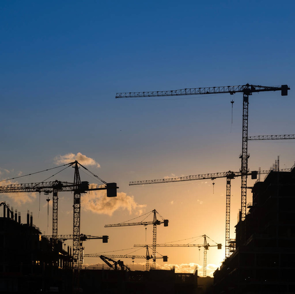 Industrial construction cranes and building silhouettes - Photo, Image