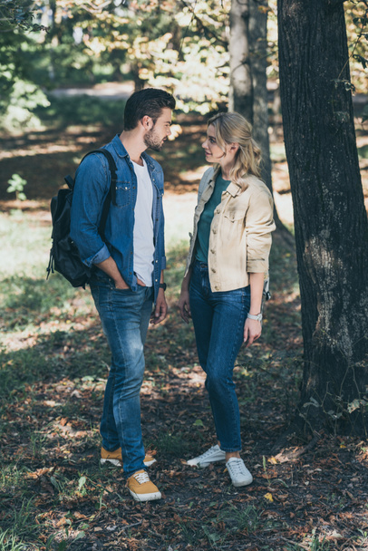 young stylish couple looking at each other in autumn park - Foto, imagen