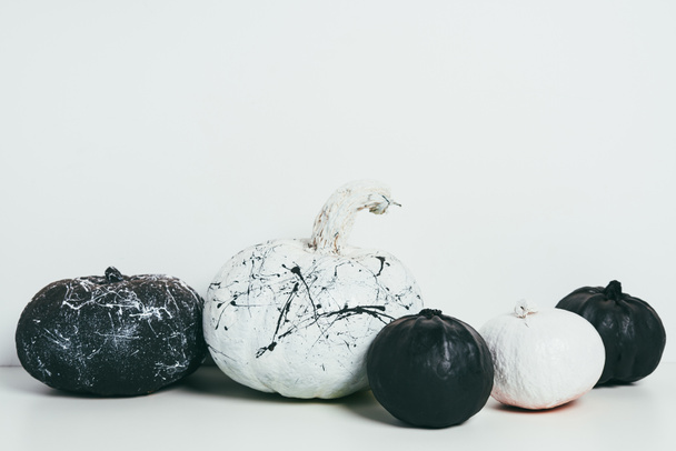 scary decorative black and white pumpkins with paint splatters for traditional halloween party - Foto, immagini