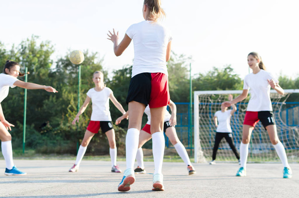 Young female handball players are playing match outside. - Zdjęcie, obraz