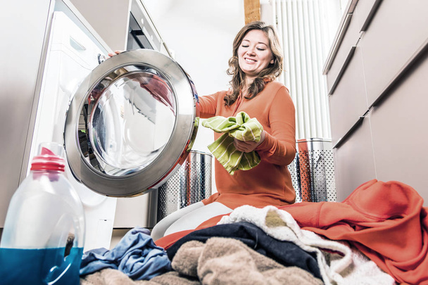 Woman loading washing machine - Foto, imagen