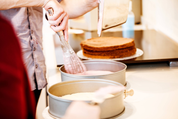 female hands in pastry shop bakery making pies and cakes ready - Foto, afbeelding