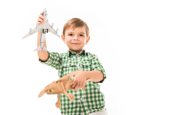 hymyilevä pieni poika leikkii lelu lentokoneita eristetty valkoisella taustalla
 - Valokuva, kuva