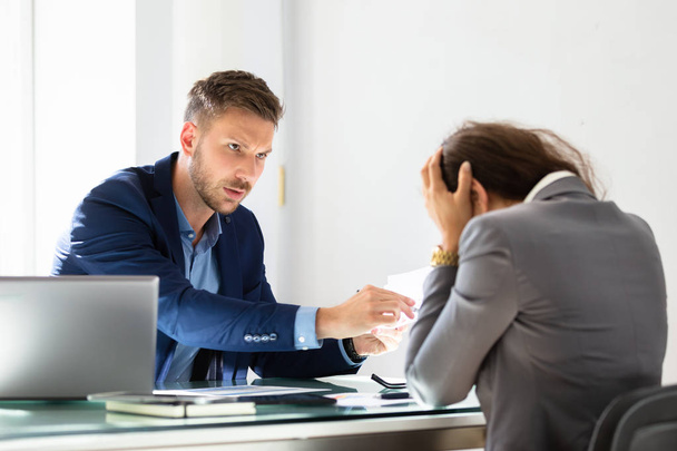 Young Businessman Shouting At Stressed Female Employee In Office - Foto, Imagem