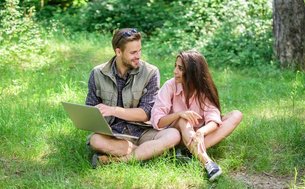 Nature best workspace. Modern technologies give opportunity to be online and work in any environment conditions. Man and girl looking at laptop screen. Couple youth spend leisure outdoors with laptop - Фото, изображение