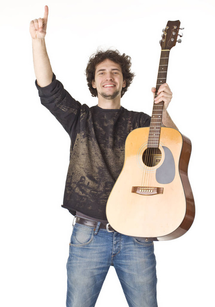 Young smiling man keeping gitare and pointing finger up - Фото, зображення
