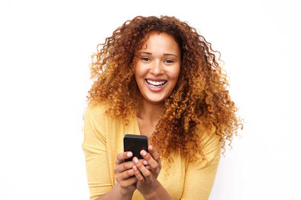 Close up portrait laughing young woman with mobile phone against white background - Φωτογραφία, εικόνα