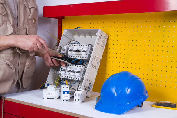 electrician fixing  electrical devices with different tools - Photo, image