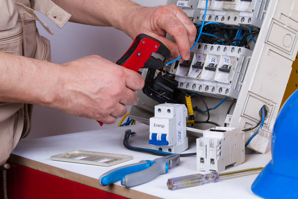 electricista fijación de dispositivos eléctricos con diferentes herramientas
 - Foto, Imagen