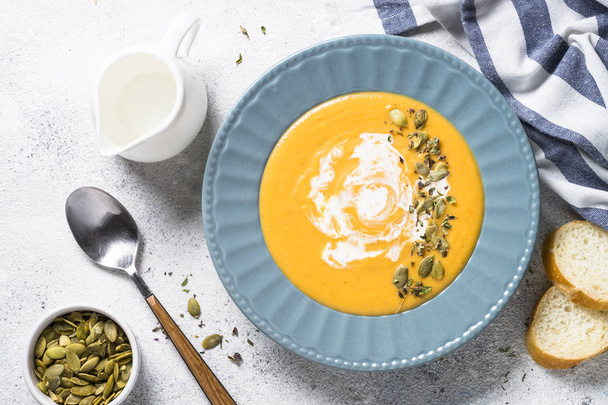 Pumpkin cream soup on light stone table. - Photo, Image
