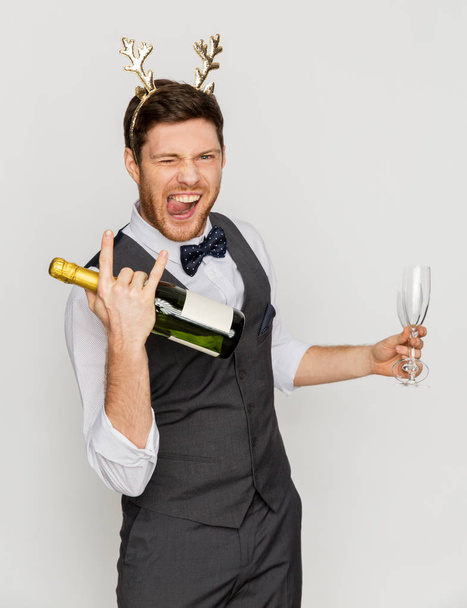 man with bottle of champagne at christmas party - 写真・画像