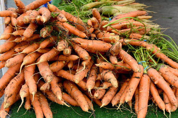 Carrots Stacked on Table at Farmer's Market - Photo, Image