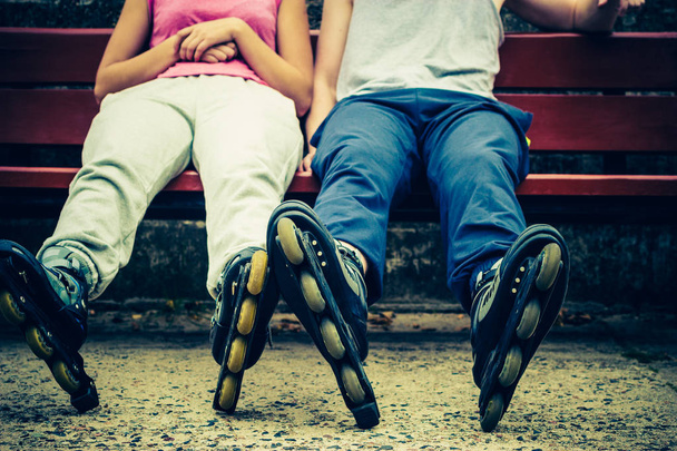 Closeup of people friends with roller skates. Woman and man relaxing outdoor. - Photo, image