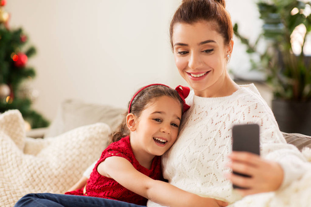 family taking selfie by smartphone at home - Valokuva, kuva