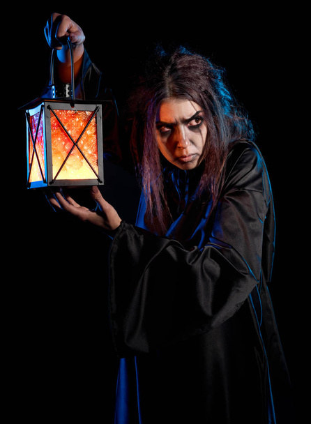 Scary witch isolated on black - 写真・画像