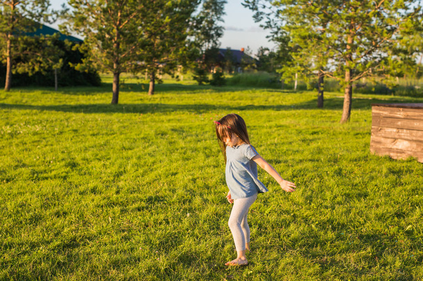 Little happy girl having fun in a summer park. - Fotografie, Obrázek
