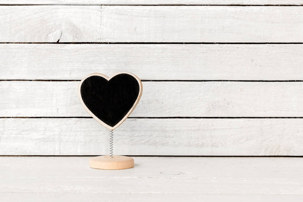 Heart Blackboard Shaped over white wood background - Foto, Imagen