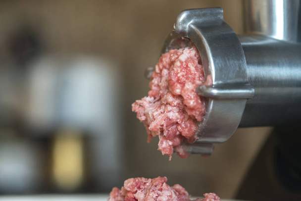 meat is ground in a meat grinder - Foto, Imagem