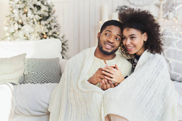 Couple relaxing with glass of warm wine on winter evening - Photo, Image