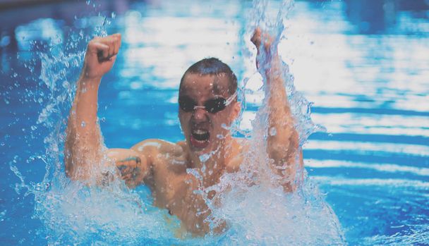 Male swimmer at the swimming pool. Underwater photo - Φωτογραφία, εικόνα