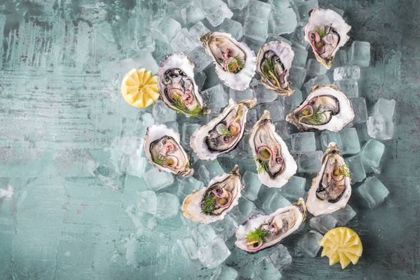 Fresh raw oysters and lemon - Fotó, kép
