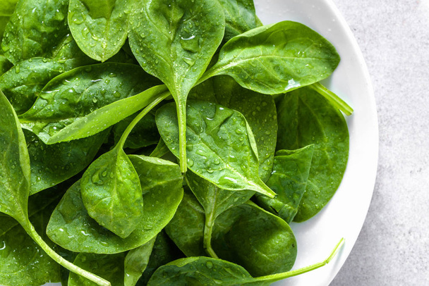 Fresh vegetables, green spinach on plate, healthy food, vegan diet concept - Fotografie, Obrázek