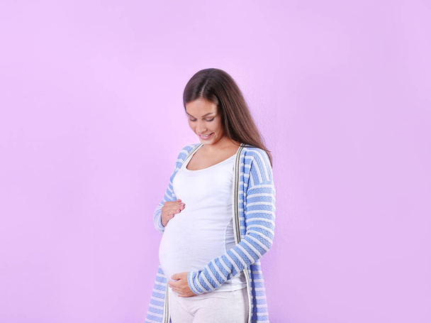 Happy pregnant woman posing on white background - Фото, зображення