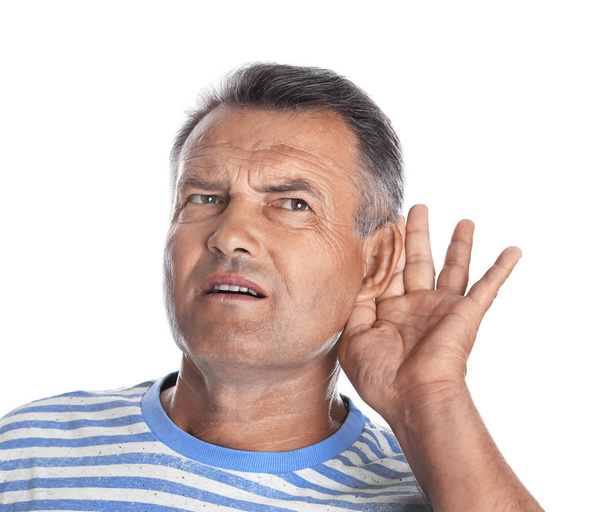 Mature man with hearing problem on white background - Foto, imagen