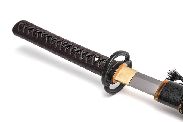 Кожаный шнур на рукоятке Японский меч стальной фитинг и черные ножницы на белом фоне
. - Фото, изображение