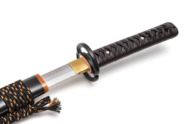 Brown leather cord tie on grip Japanese sword steel fitting and black  scabbard on white background. - Photo, Image