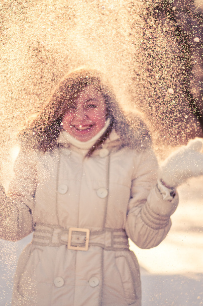 Happy young woman plays with a snow - Zdjęcie, obraz