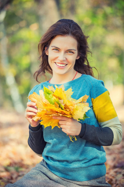 Happy young woman in autumn park - Photo, Image