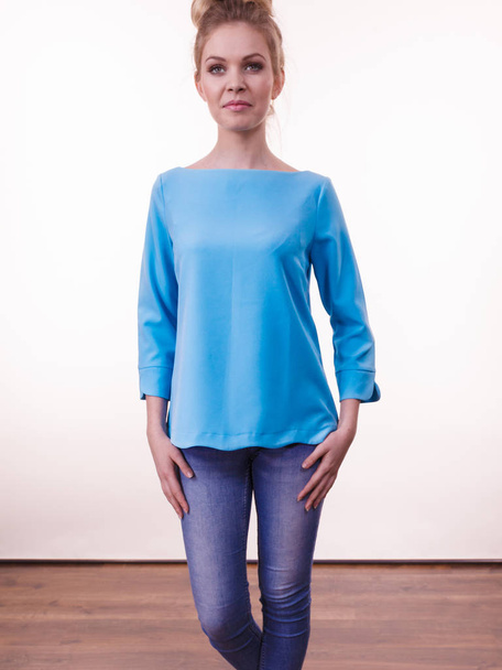 Adult woman presenting her casual beautiful outfit, long sleeved blue top and jeans. - Fotó, kép