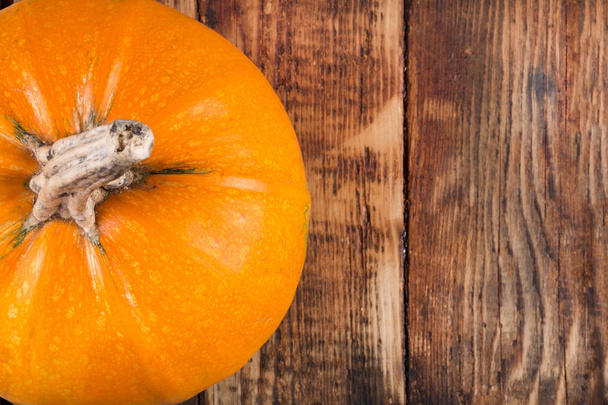 Orange pumpkin on retro wooden background. Copy space for text. Halloween, Thanksgiving day or seasonal autumnal concept. Close up, selective focus - Valokuva, kuva