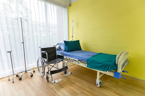 Habitación de hospital con cama vacía, set de infusión, fluido intravenoso y sillas de ruedas para crear diseño y decoración sobre fondo. Copiar espacio
. - Foto, imagen