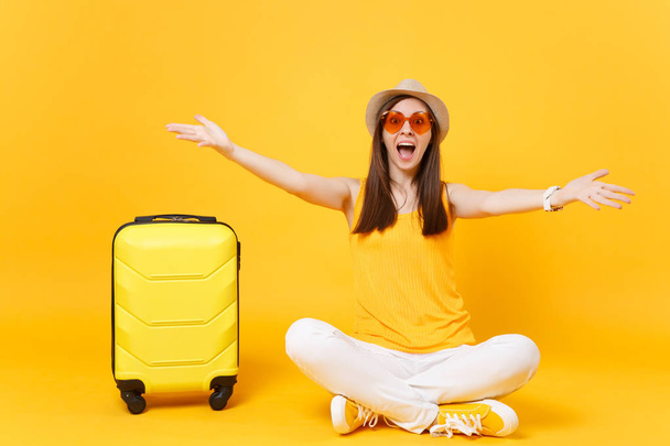 Eller izole sarı turuncu arka plan üzerinde yayılan eğlenceli turist kadın yaz rahat kıyafetler, çanta, şapka sit. Hafta sonu kaçış üzerinde seyahat için yurt kız. Hava uçuş kavramı - Fotoğraf, Görsel