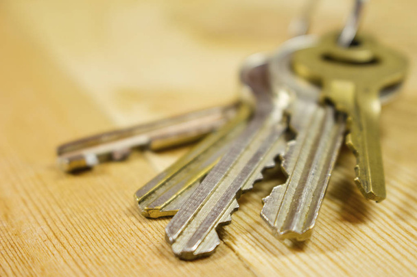 a bunch of keys on a wooden table - Photo, Image