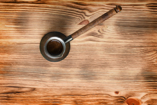 Ahşap zemin üzerine bakır Türk kahvesi ot üstten görünüm - Fotoğraf, Görsel
