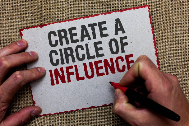 Word writing text Create A Circle Of Influence. Business concept for Be an influencer leader motivate other people On jute ground human hand written some texts on red bordered paper. - Photo, Image