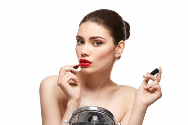 girl applying red lipstick isolated on white - Photo, image