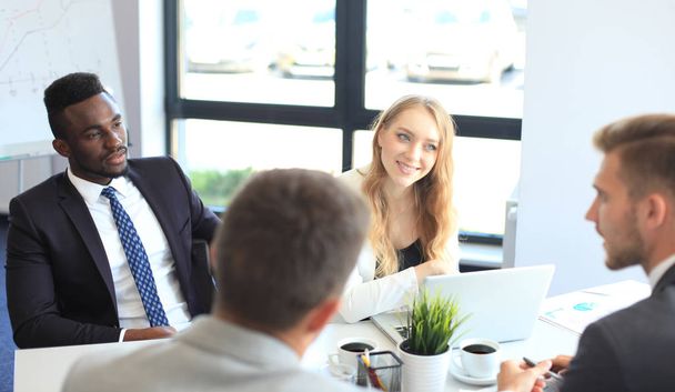 Business people in discussing something while sitting together at the table. - Photo, image